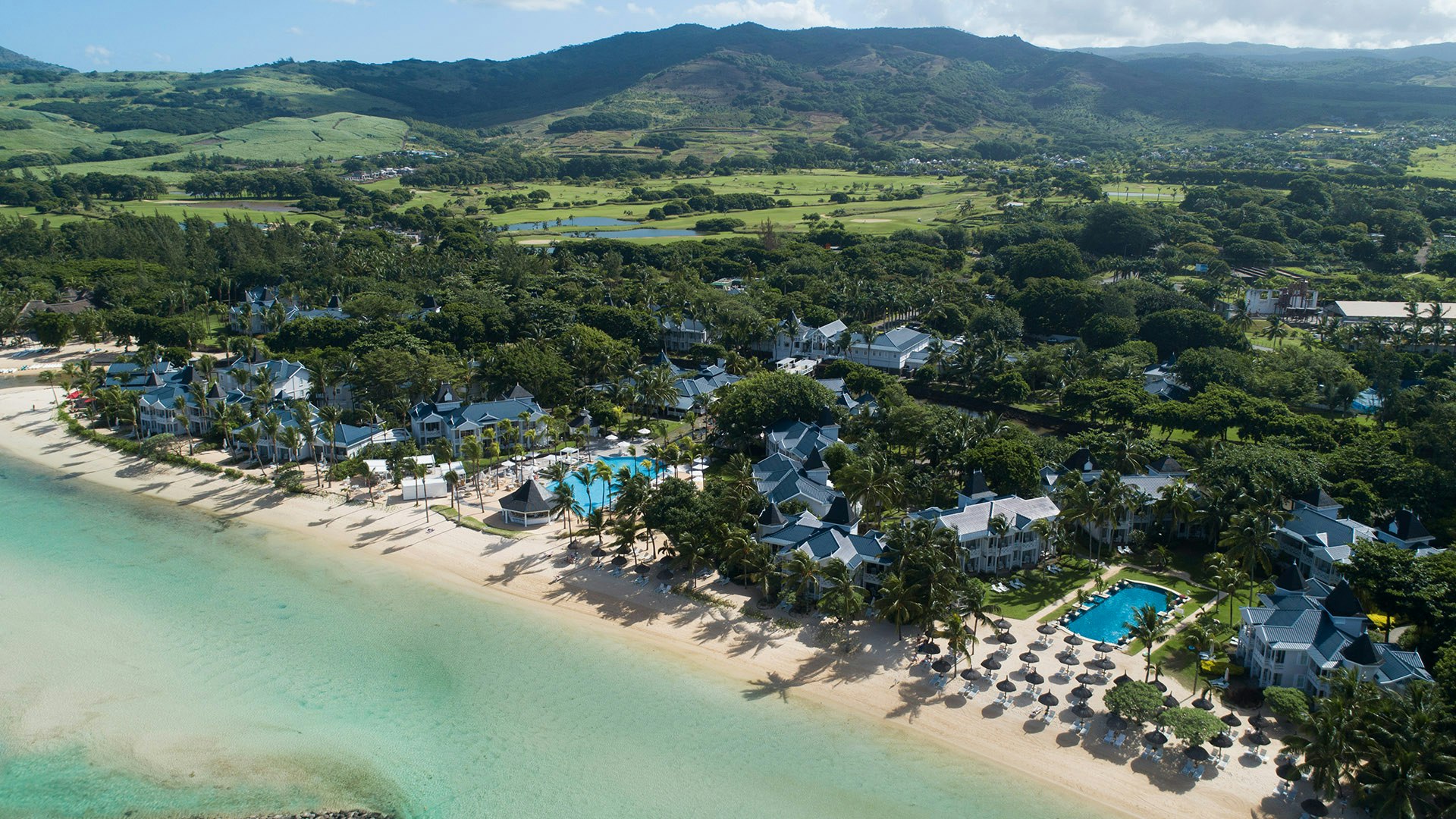Heritage Le Telfair Golf and Wellness Resort in Mauritius with colonial-style buildings, beach and tropical gardens
